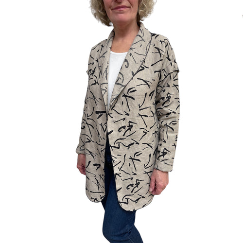 Person wearing a patterned beige jacket on a white background
