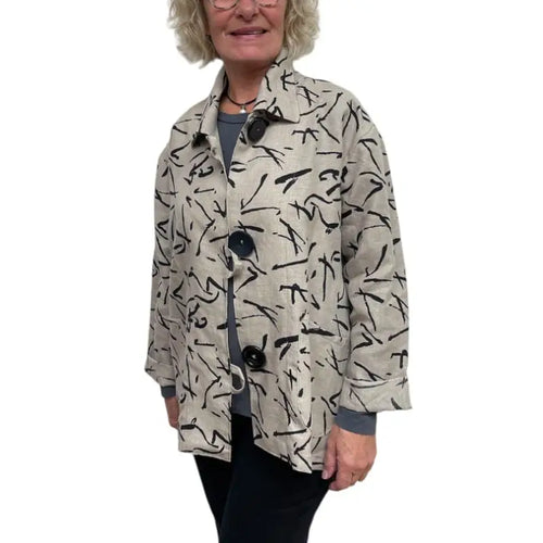 Person wearing a patterned beige jacket on a white background