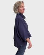 Right side view of relaxed fit eggplant cowl neck tunic in wool suiting worn alone