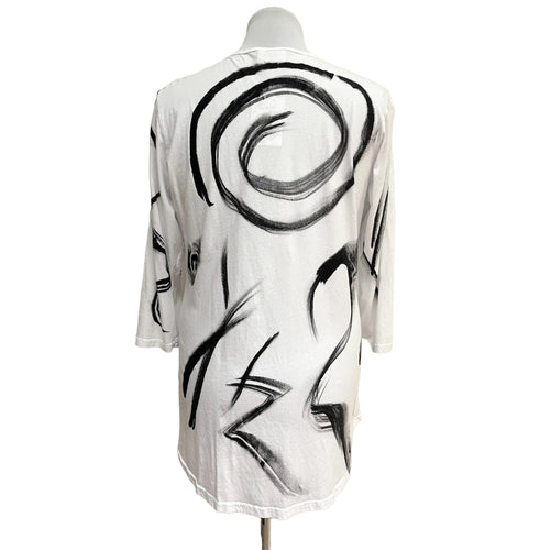 Mannequin wearing a white garment with black abstract patterns on a white background