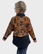 Back of rust black white cotton mudcloth bolero jacket with relaxed sleeves, one size