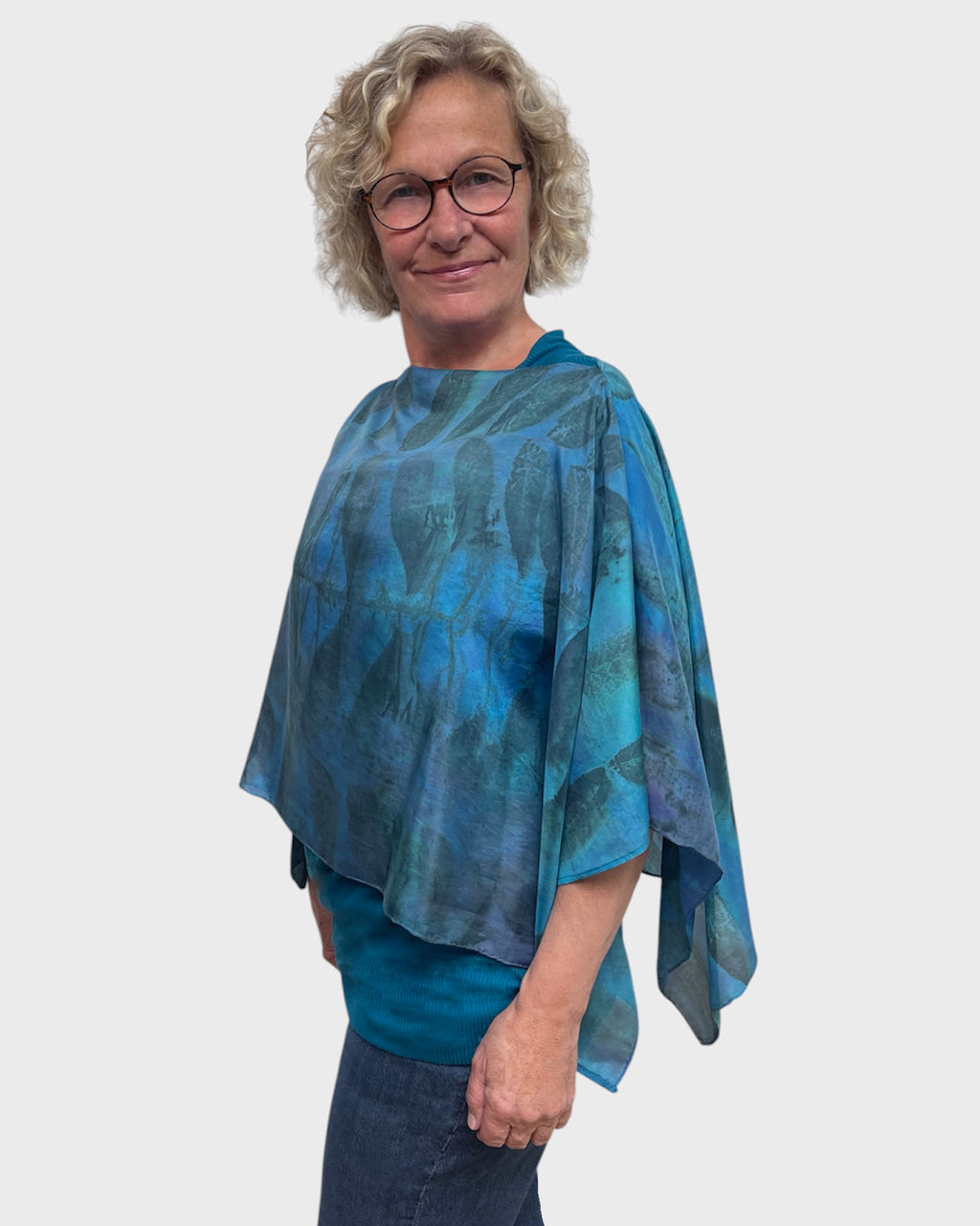 Turquoise silk poncho worn open, side profile showing drape and flow of Habotai silk