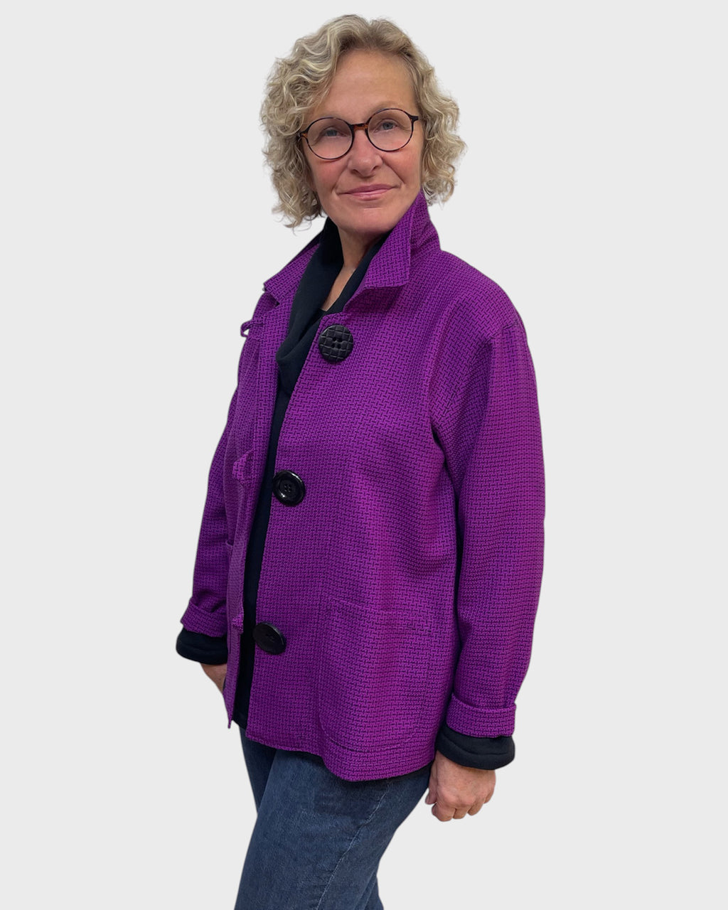 Fuchsia black classic jacket buttoned with collar worn up over a black cowl neck top