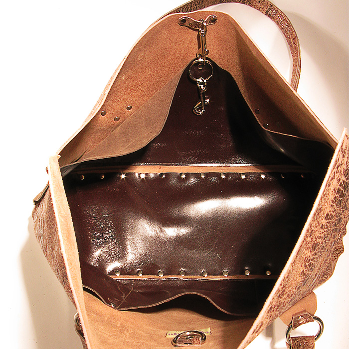 Distressed brown riveted cowhide purse
